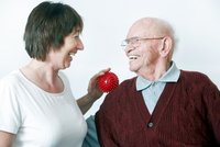 Senior und Pflegende mit Therapieball